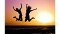 The image shows two people and a sunset.