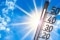 The image shows a thermometer in the sun.