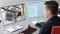 The image shows an employee working on a computer.
